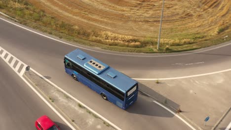 blue bus with air condition turns left on the crossroad on asphalt road