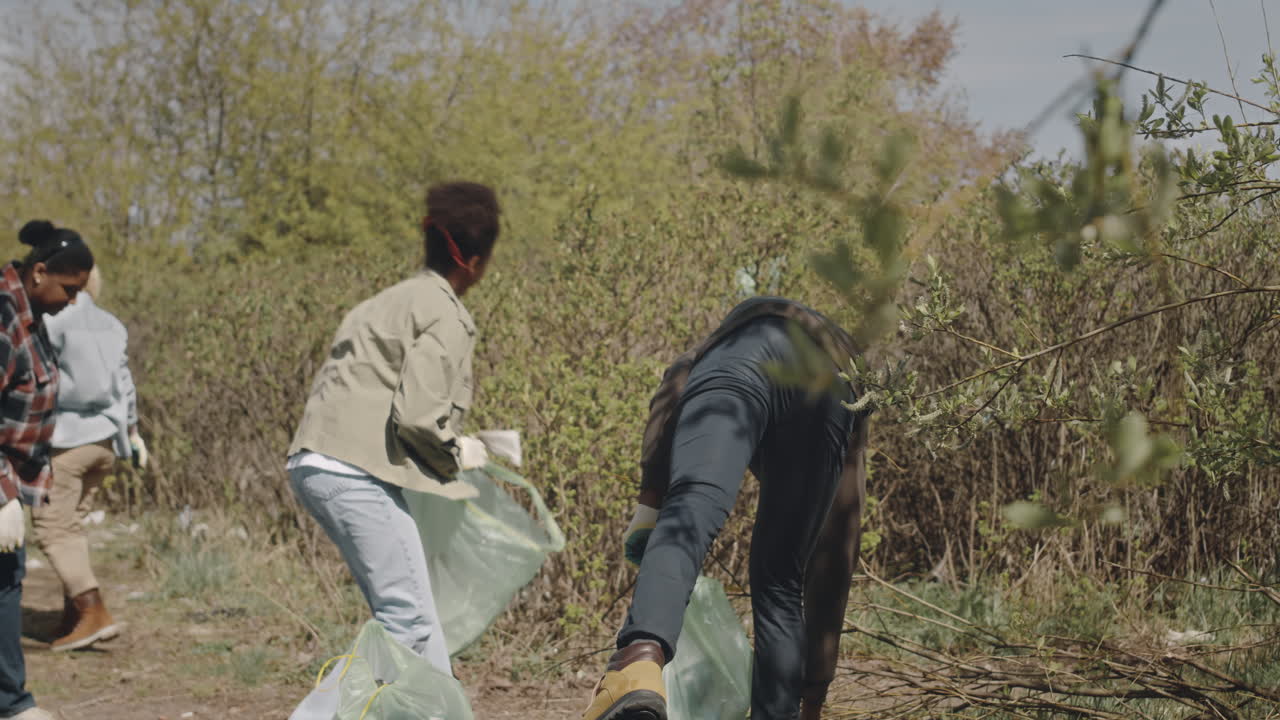 Group of Environmental Volunteers Doing Forest Cleanup