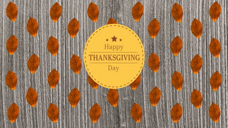 animation of happy thanksgiving day text over wooden background with autumn leaves