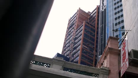 looking up at tall hong kong buildings