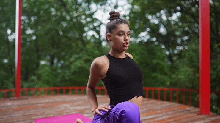 Young woman doing yoga outdoors