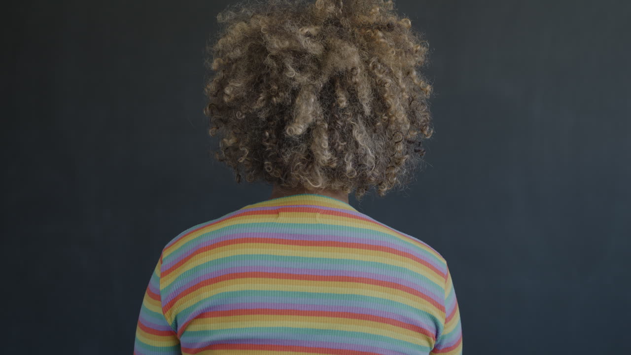 Smiling Woman with Curly Hair and Striped Shirt