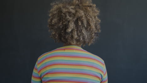 smiling woman with curly hair and striped shirt