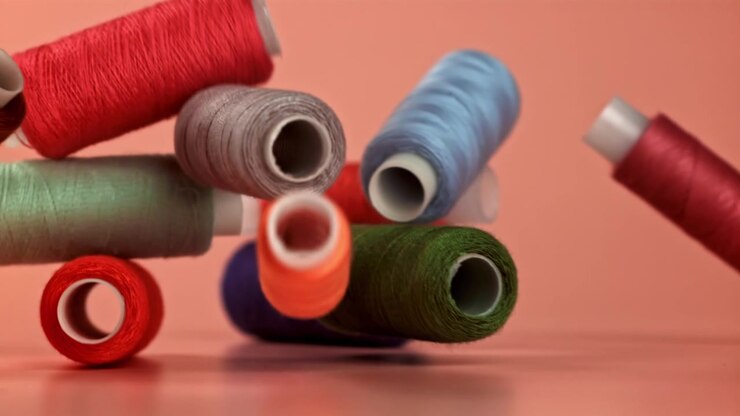 Colorful Sewing Thread Spools Falling in Slow Motion