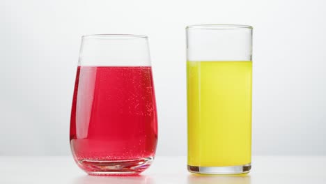 two different colored drinks in hands