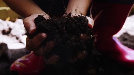 Woman-holding-fertile-soil