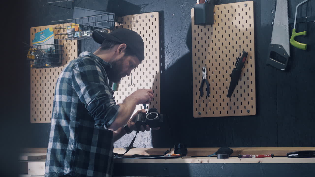 Man restoring old camera at home, diy concept