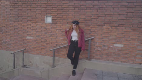 two friends have fun taking pictures in the street. the photographer directing her friend for the poses