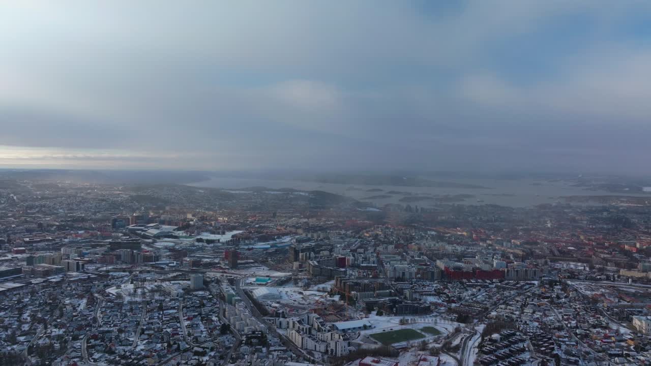 Oslo Fjord downtown cityscape Norge Norway aerial drone Gamle Tonsengagen Bjerke Arvoll morning buildings cars traffic highway roads snowing snow flakes cold cloudy winter day gray skies static