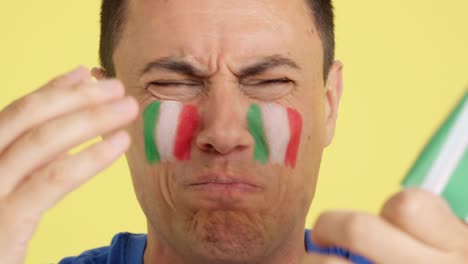 man with italian national flag upset with a referee