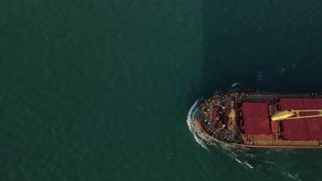 Freighter-passing-on-Detroit-River,-on-a-Sunny-day,-Birds-eye-Aerial-View