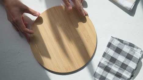 wooden dish board on white wooden table ,top view, food menu card or recipes background concept, eco friendly wooden kitchenware.