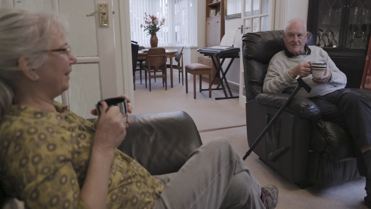 Elderly couple relaxing in their living room