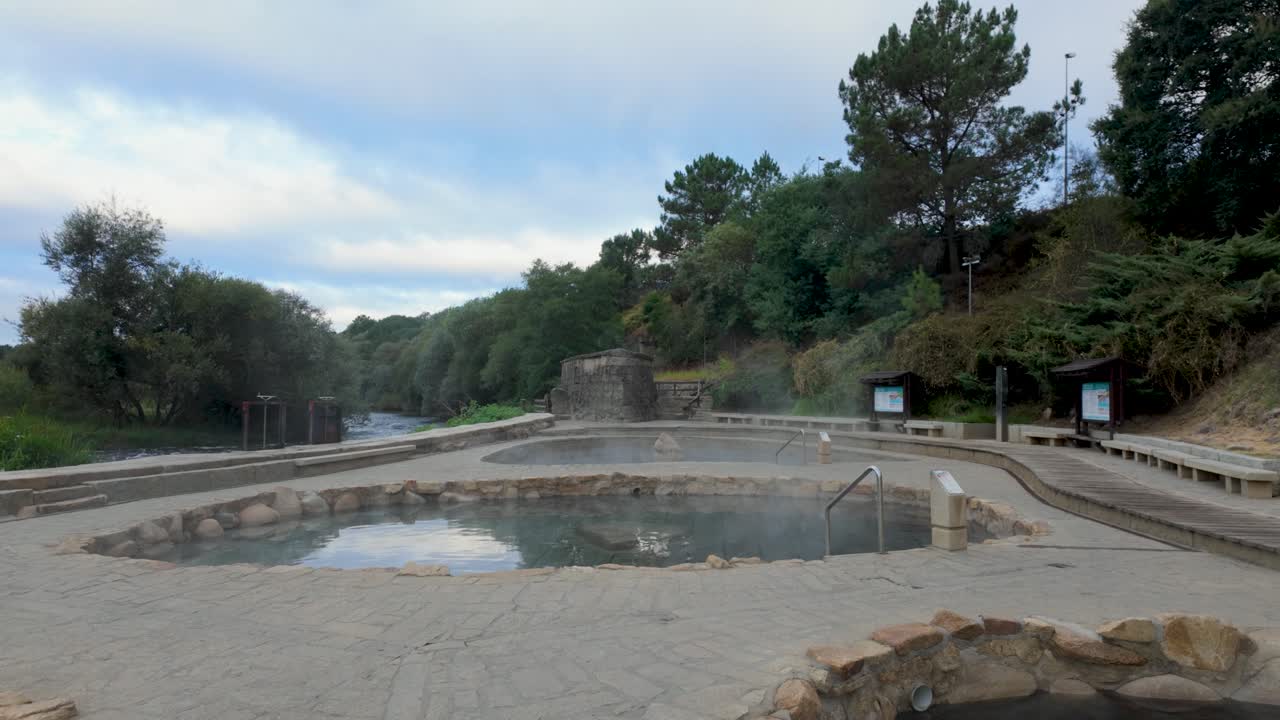 Establishing shot of Muiño da Veiga thermal baths in Ourense, Galicia, Spain