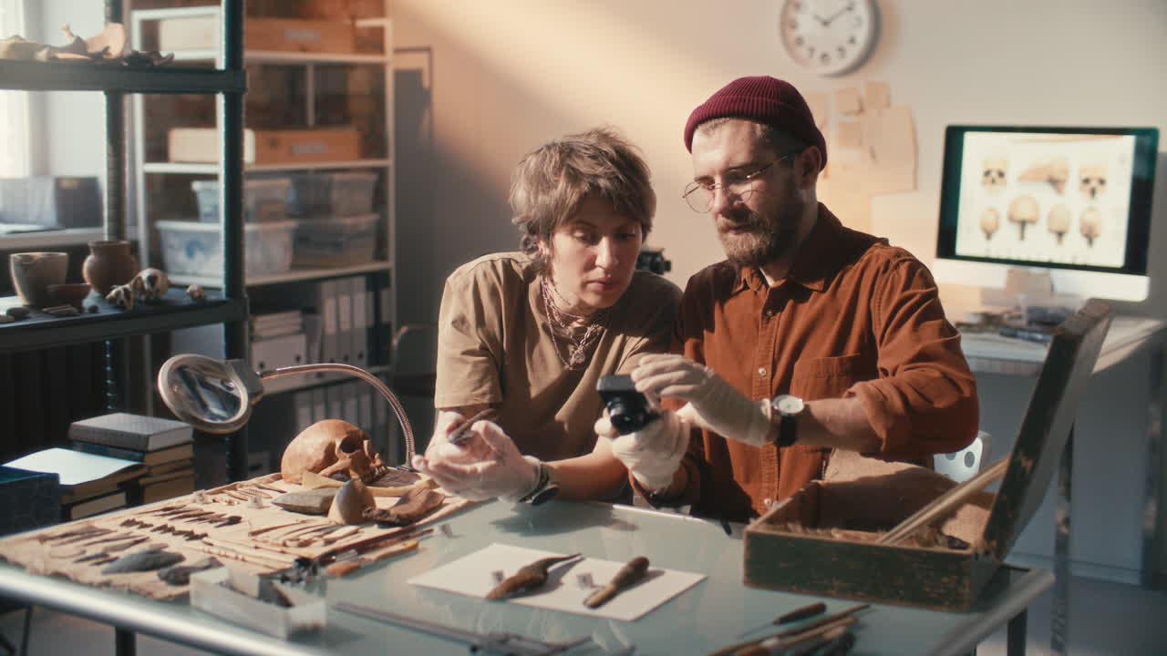 Two Archaeologists Photographing and Documenting Artifacts in Laboratory