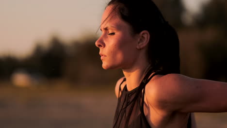 Push-ups-or-press-ups-exercise-by-young-woman.-Girl-working-out-on-grass-crossfit-strength-training-in-the-glow-of-the-morning-sun-against-a-white-sky-with-copyspace.