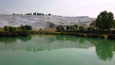 pamukkale, meaning "cotton castle" in turkish, is a natural site in denizli in southwestern turkey. the area is famous for a carbonate mineral left by the flowing water.