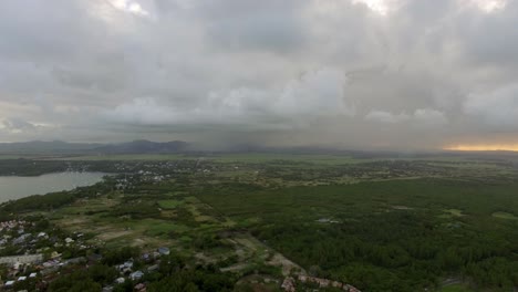 flying over mauritius island with low clouds