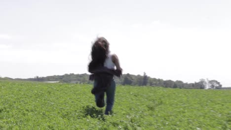 Hand-held-Shot-Of-A-Young-Girl-Running-Towards-The-Top-Of-The-Hill