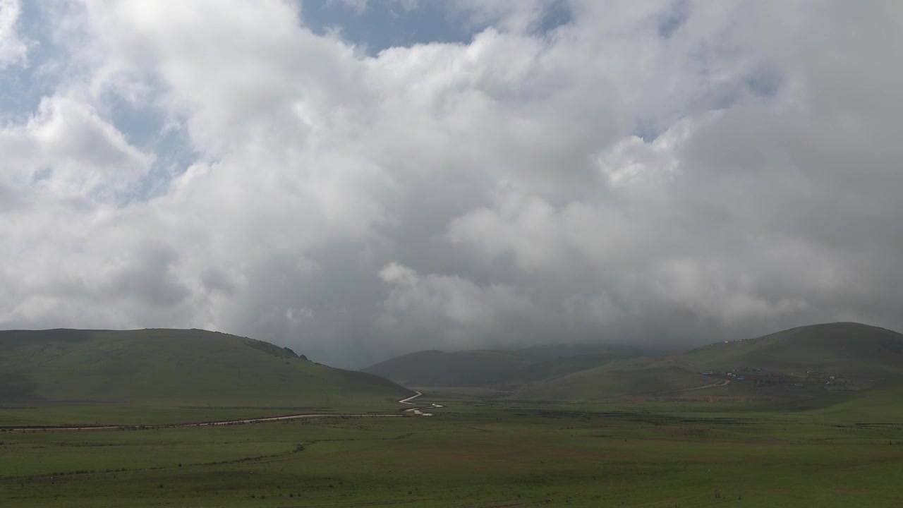 Dramatic Clouds Over Rolling Green Highland Hills