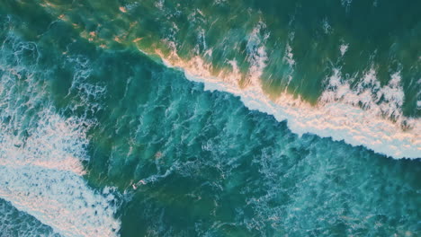 top view foaming ocean surface waving super slow motion. rough sea waves rolling