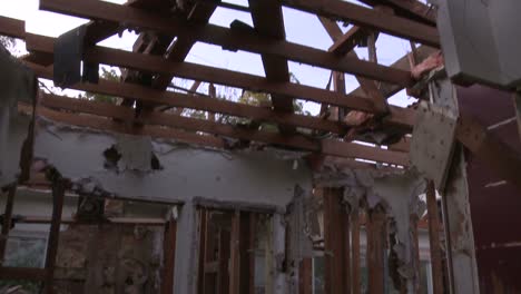 Tilt-down-from-roof-beams-and-panning-shots-around-a-house-in-the-process-of-being-demolished