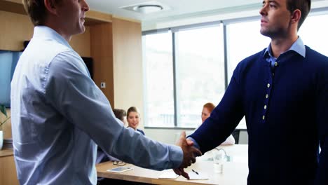 Executives-shaking-hands-in-office