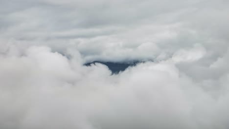 aerial view of dense cloud cover with a small opening in the sky
