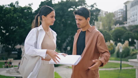 Focused-business-couple-working-with-papers.-Businesswoman-analyzing-documents