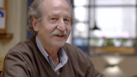 senior man having dinner in restaurant