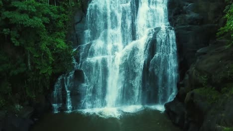 ascending slow motion aerial shot revealing beautiful big waterfall in woods