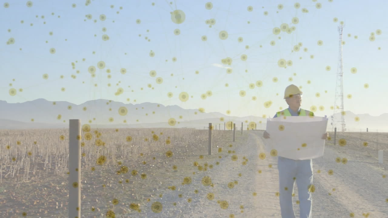 Construction worker examining blueprint while walking gravel road, with animated dust particles