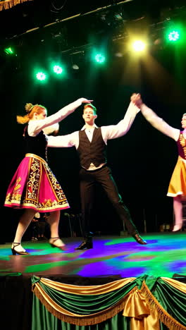 folk dancers performing on stage in traditional costumes