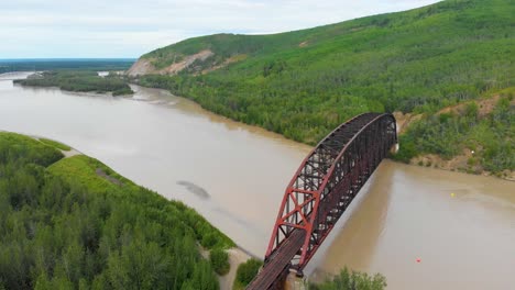 4K-Drone-Video-of-Mears-Memorial-Steel-Truss-Train-Bridge-over-the-Tanana-River-at-Nenana,-Alaska-during-Summer-Day