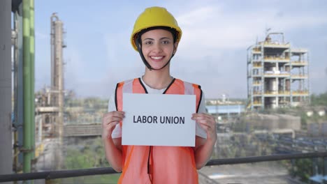 happy indian female construction worker holding labor union banner