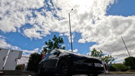 ev parked as clouds drift overhead