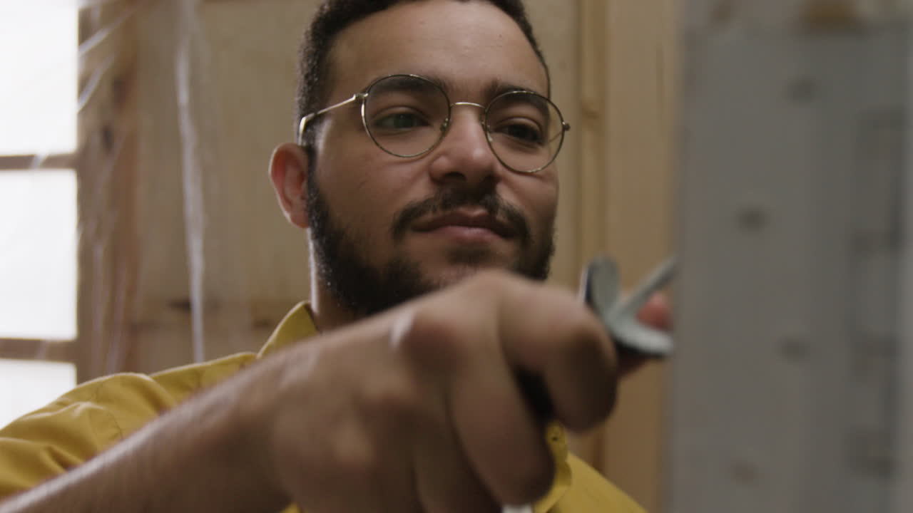 Man in yellow shirt wearing glasses