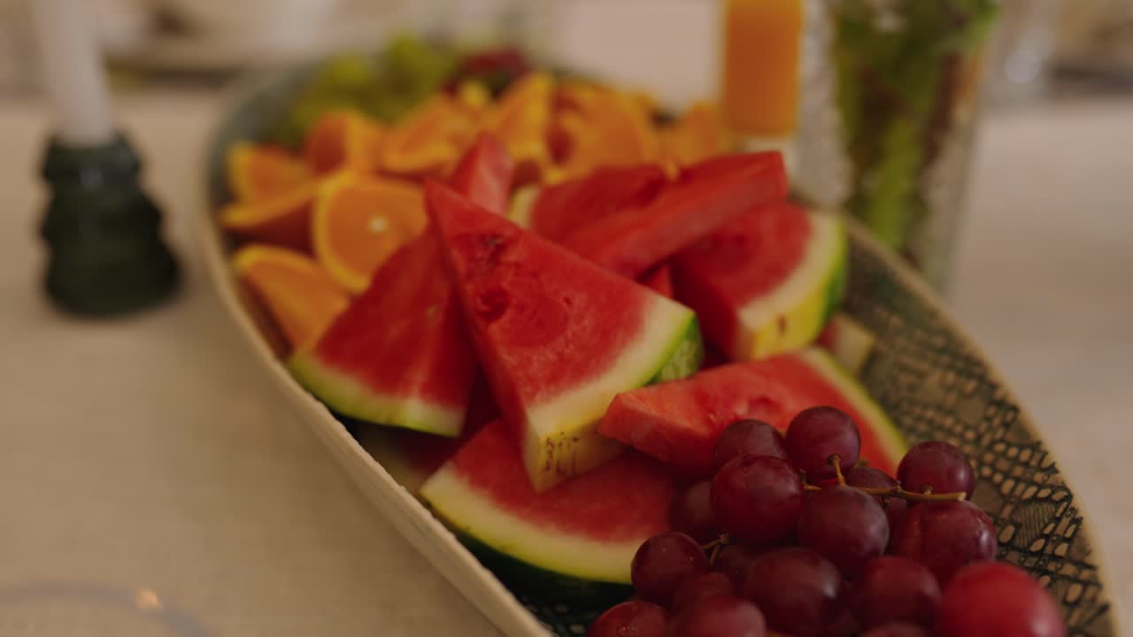 A plate of colourful nutritious fruit on a table