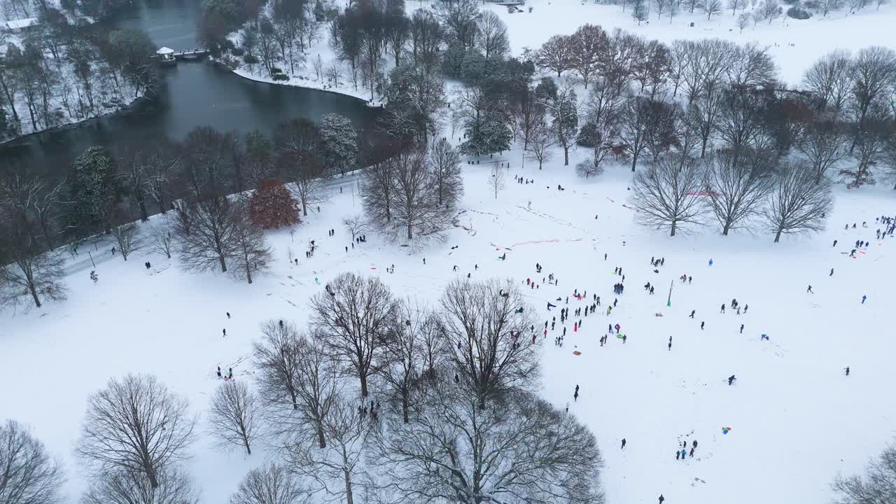 Static aerial shot of people sledding in Piedmont Park Atlanta.