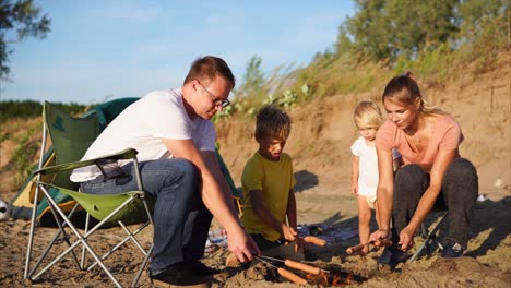 family camping trip with hot dogs