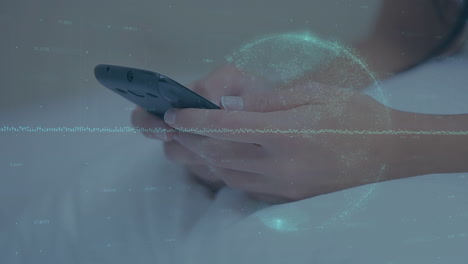 spinning globe and statistical graphs against close up of a woman using smartphone in bed