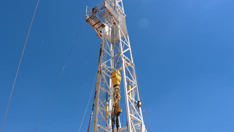 a rig for production oil and gas. working equipment in the deserted area. low angle view on the tower drilling resources.