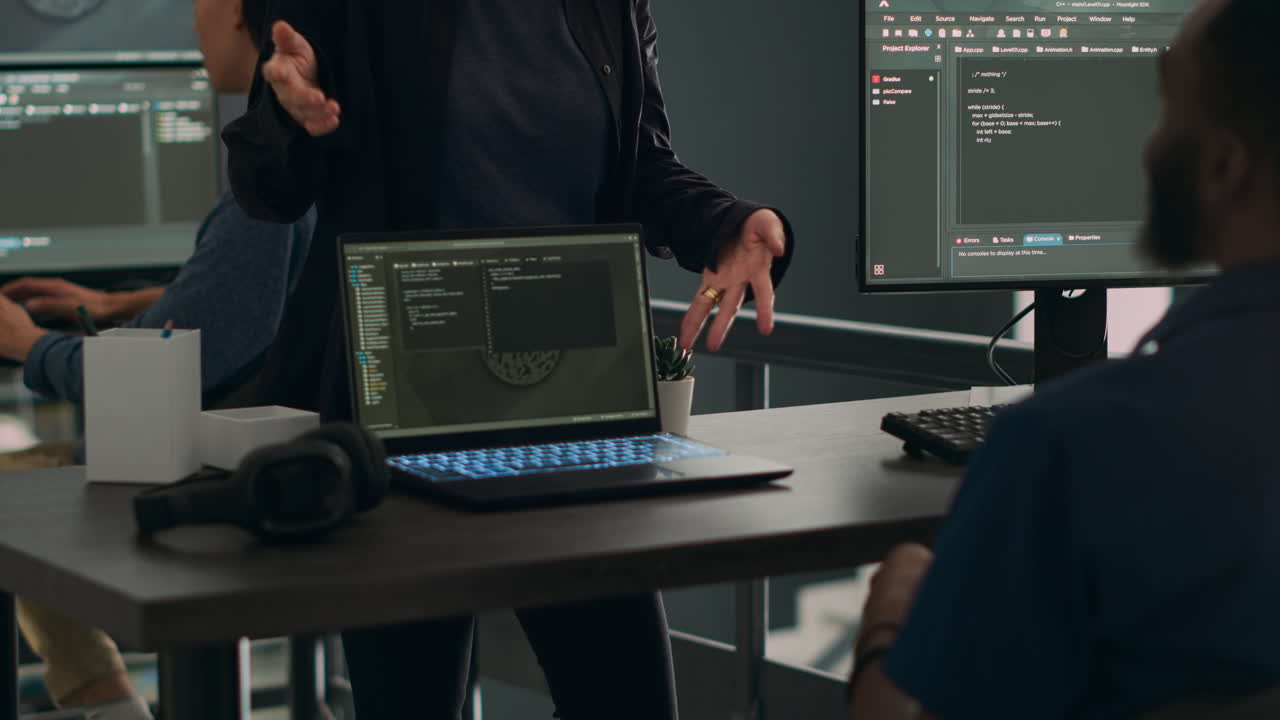 Programmers collaborating on group project talking about coding algorithm