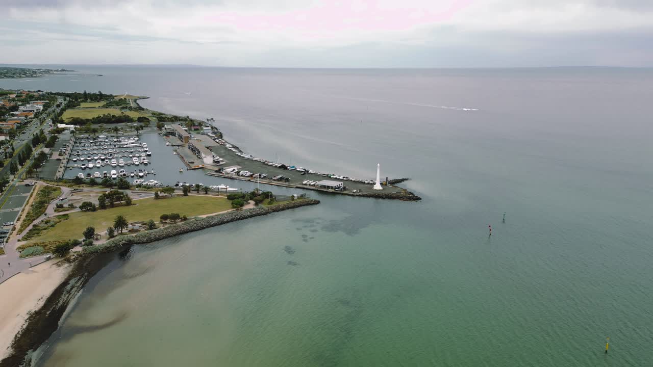 Aerial footage of a gradual approach towards the St Kilda Beach, in Melbourne Australia. The pristine waters lead out far in the horizon.