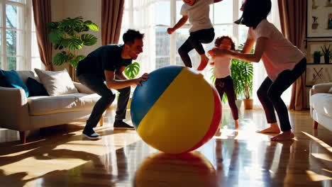 family playing with a beach ball indoors