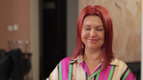 fashionable woman proudly shows off her beautiful bright red hair while wearing a colorful fashionable woman proudly shows off her beautiful bright red hair while wearing a colorful and stylish blouse