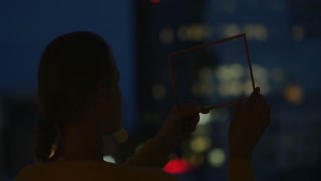 woman holding transparent tablet