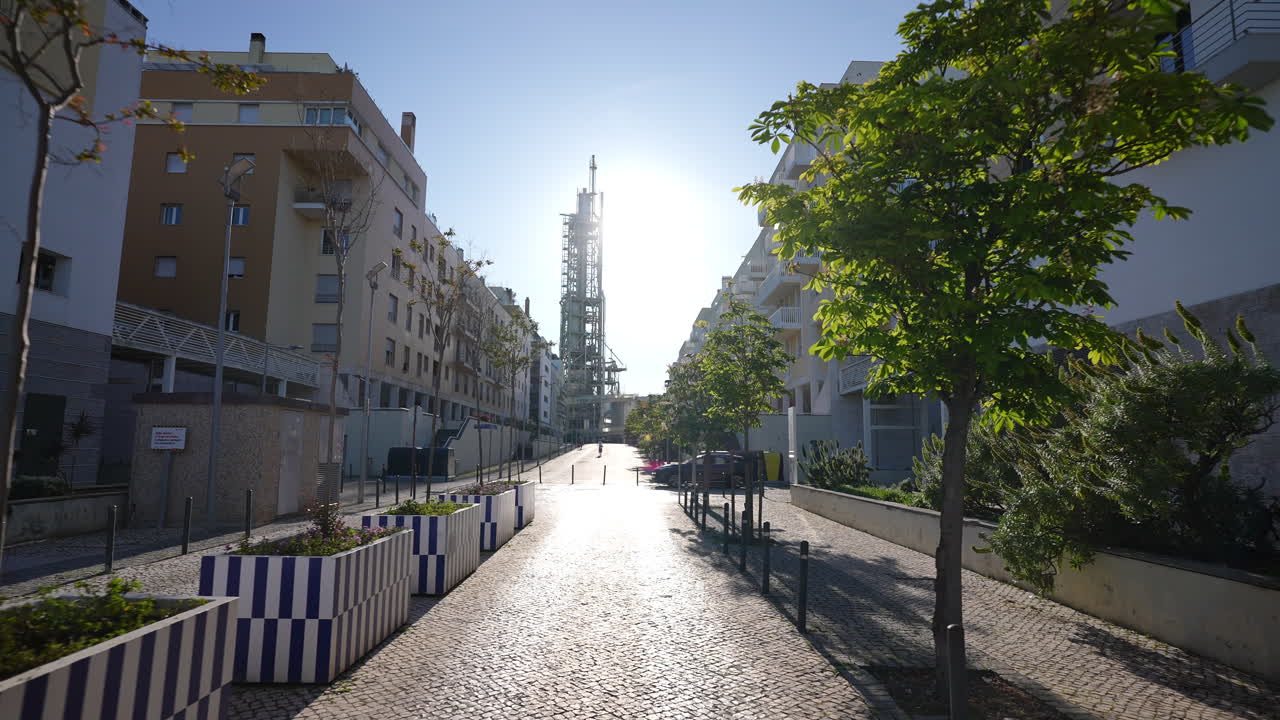 Chamine da Refinaria da GALP seen from residential street in Lisbon Parque das Nacoes with backlight and soft cinematic motion
