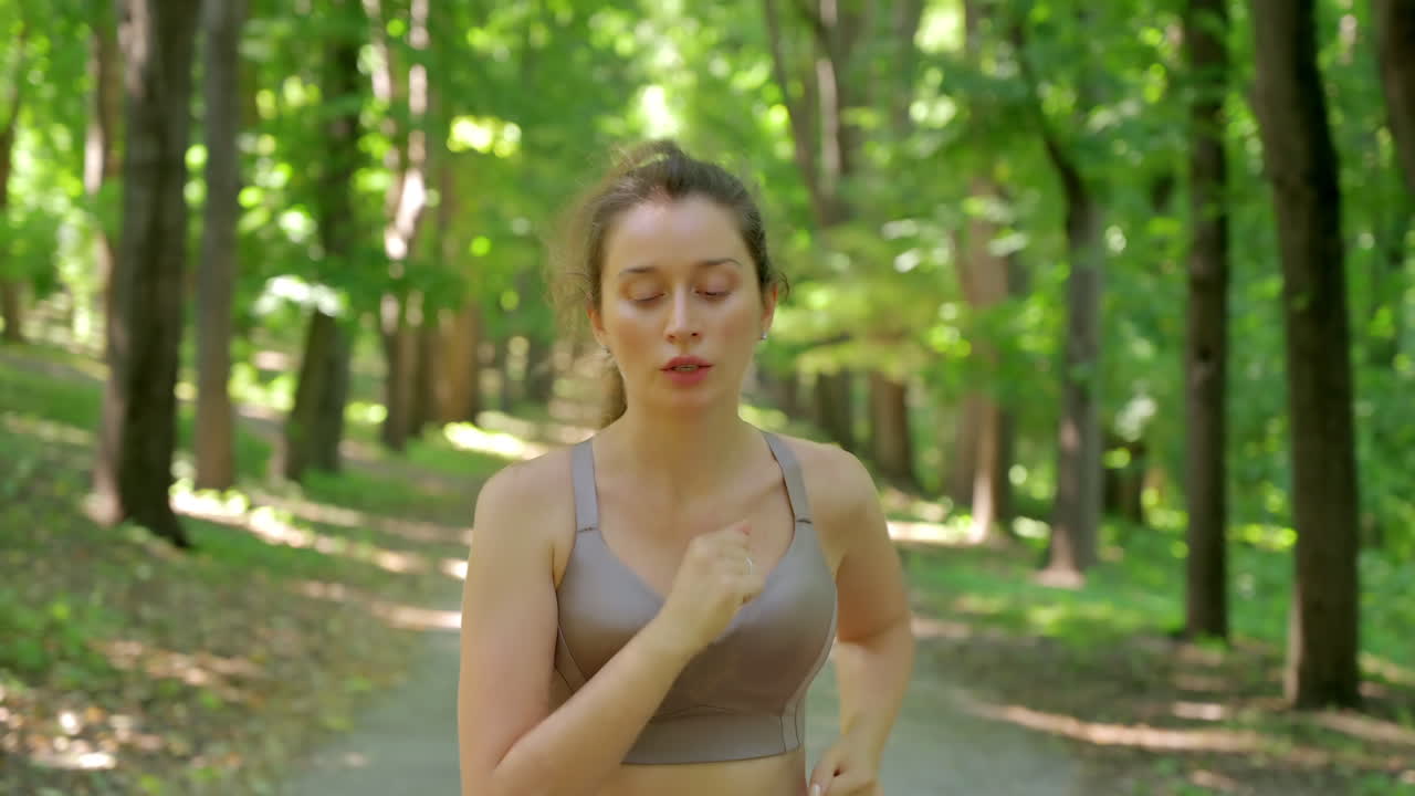 Woman in beige sportswear working out in the park