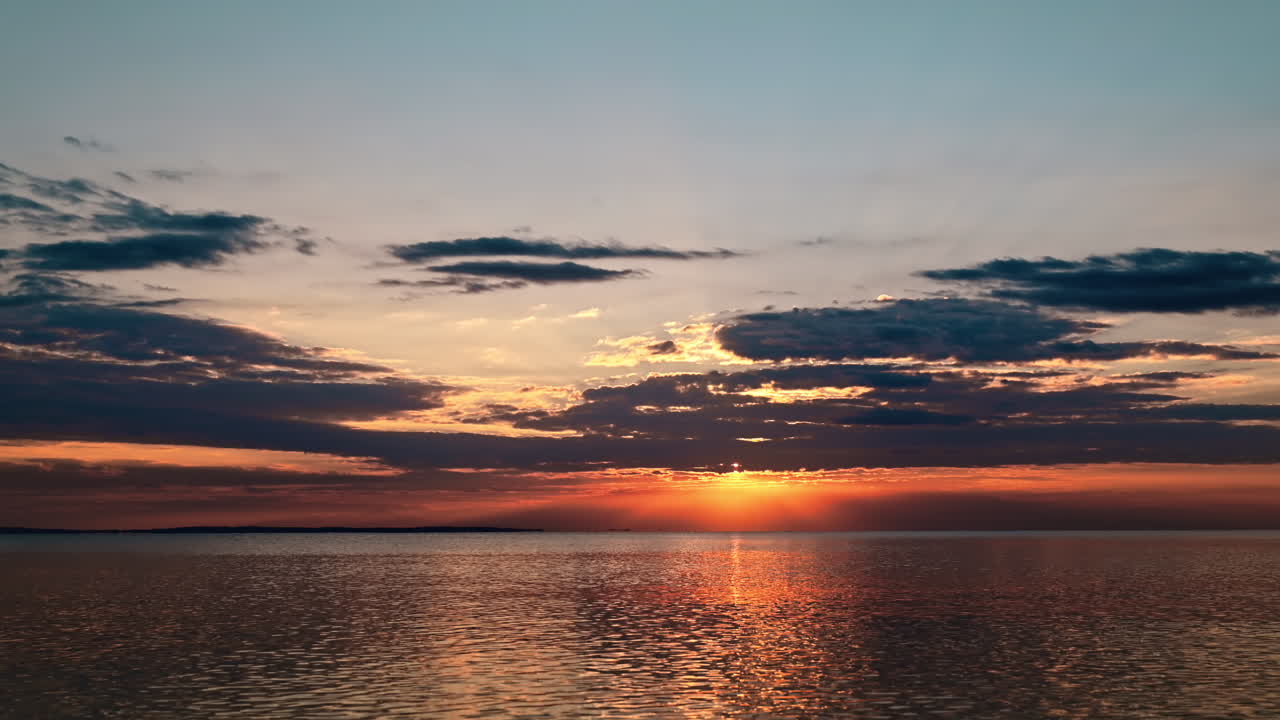 Timelapse of the sunset in Greece. Aegean sea coast, waves, clouds